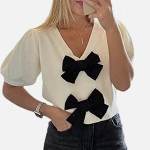 Elegant Cream Top with Black Bow Accents